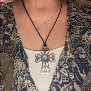 Silver Cross necklace with leather cord and silver clasp.